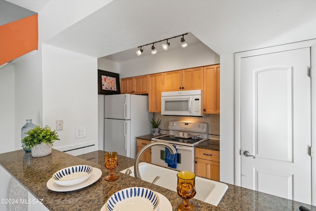 kitchen with kitchen peninsula, dark stone countertops, sink, white appliances, and tasteful backsplash