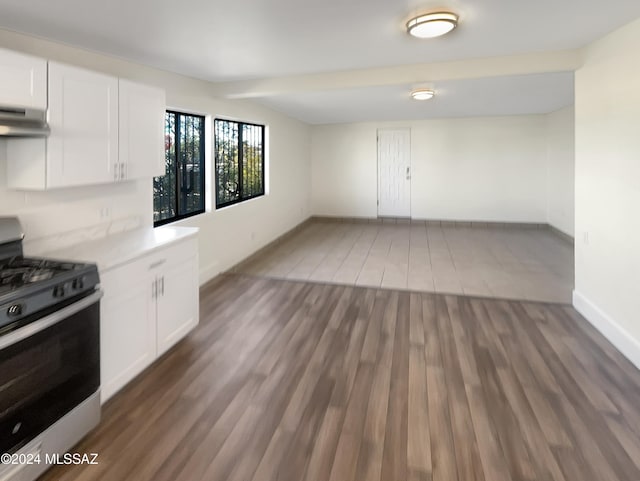 kitchen featuring exhaust hood, white cabinetry, gas stove, and dark hardwood / wood-style flooring