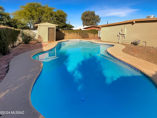 view of pool featuring a shed