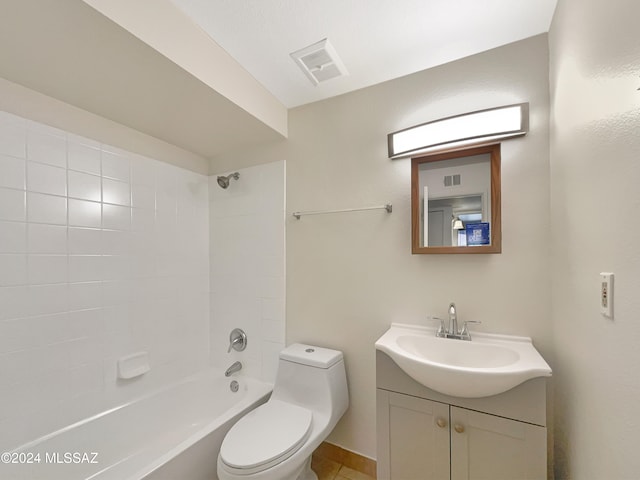 full bathroom featuring tiled shower / bath, vanity, and toilet