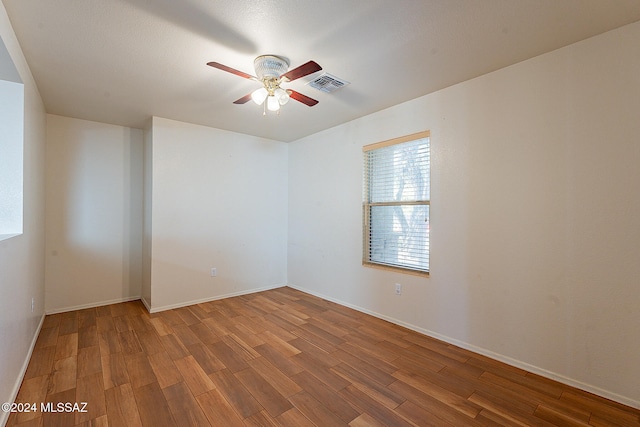 spare room with hardwood / wood-style flooring and ceiling fan