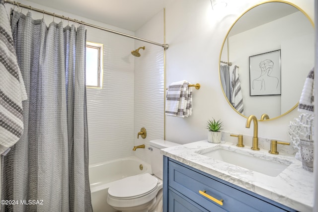 full bathroom with vanity, shower / bath combo with shower curtain, and toilet