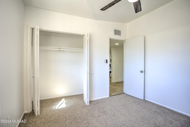 unfurnished bedroom with ceiling fan, a closet, and carpet floors