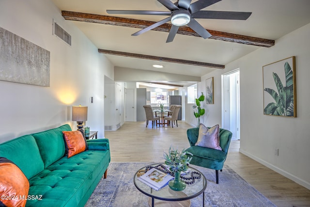 living room with lofted ceiling with beams, light wood-type flooring, and ceiling fan