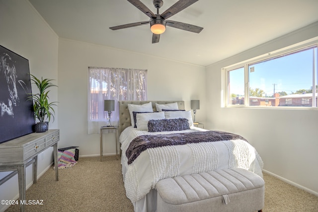 bedroom featuring ceiling fan, crown molding, vaulted ceiling, and light colored carpet