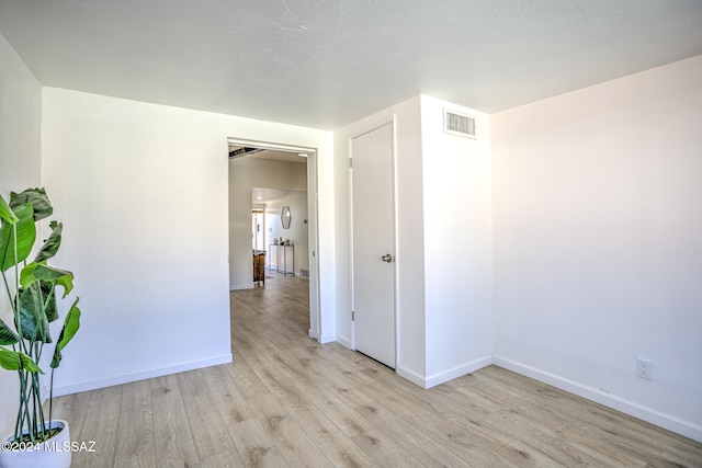 empty room with light hardwood / wood-style floors