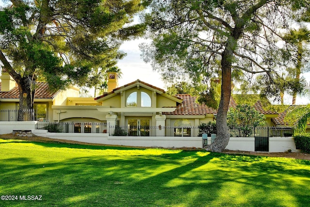 rear view of property with a lawn