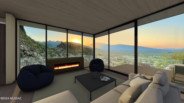 sunroom / solarium featuring a mountain view and wooden ceiling