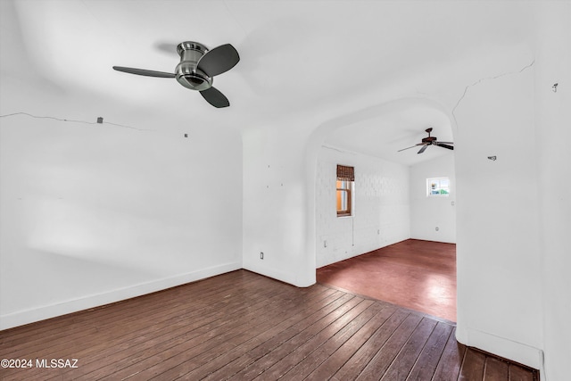 unfurnished living room with dark wood-type flooring, ceiling fan, and lofted ceiling