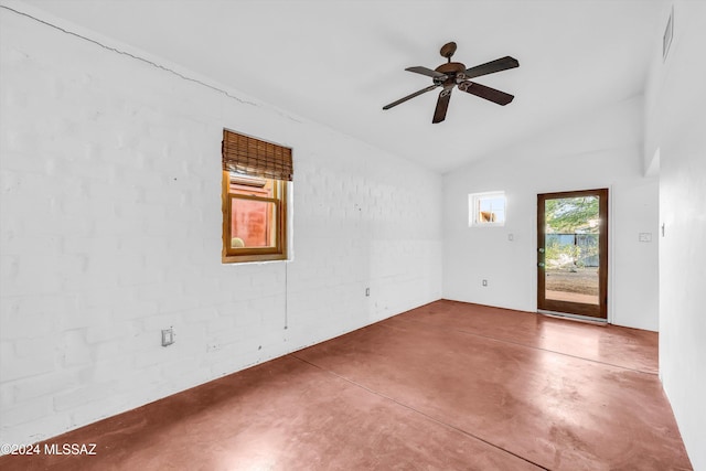 unfurnished room featuring concrete floors, vaulted ceiling, and ceiling fan