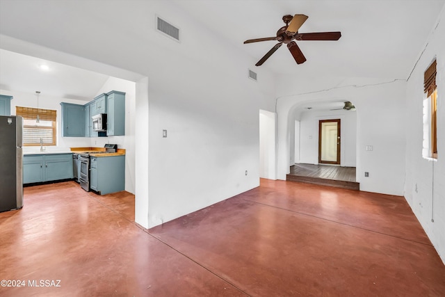 unfurnished living room featuring concrete flooring, ceiling fan, and sink