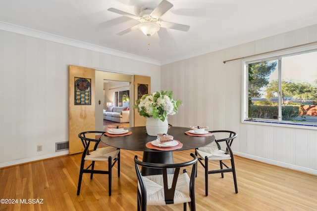 dining area with light hardwood / wood-style floors, ceiling fan, and ornamental molding