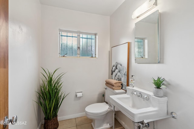 bathroom featuring an AC wall unit, sink, tile patterned flooring, and toilet