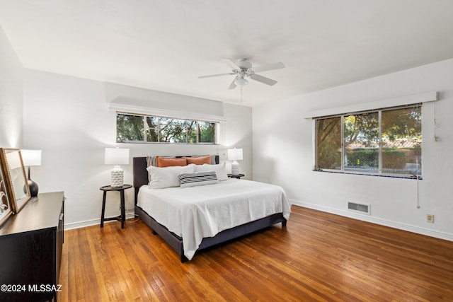 bedroom with ceiling fan and wood-type flooring