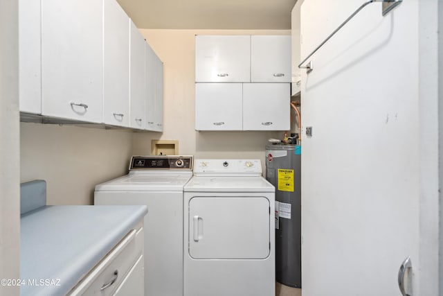 laundry area with washing machine and dryer, water heater, and cabinets