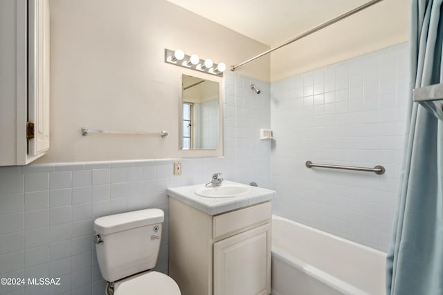 full bathroom featuring vanity, toilet, shower / bath combo, and tile walls