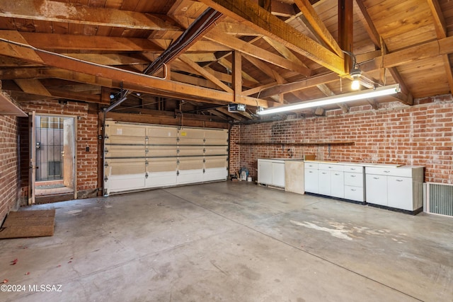 garage featuring a garage door opener and wooden ceiling