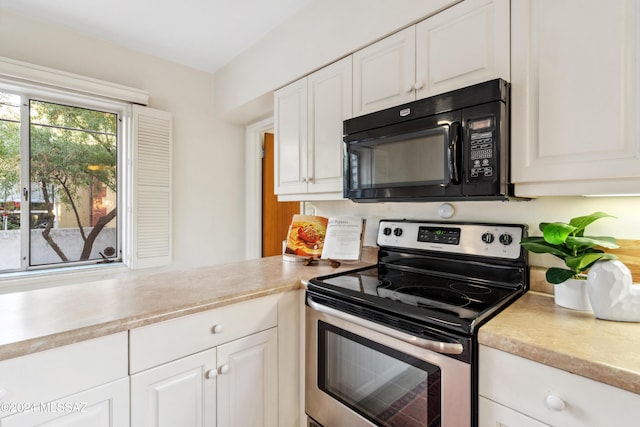 kitchen featuring white cabinets and stainless steel range with electric stovetop