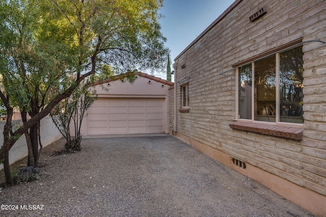 view of property exterior with a garage and an outbuilding