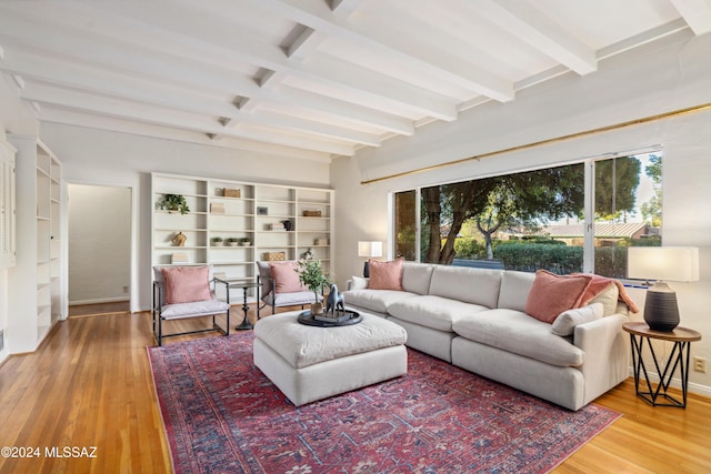 living room with beamed ceiling and hardwood / wood-style floors