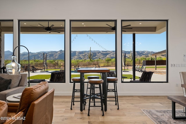 dining area with light wood finished floors and a mountain view