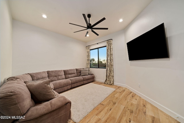 living room featuring ceiling fan and hardwood / wood-style floors