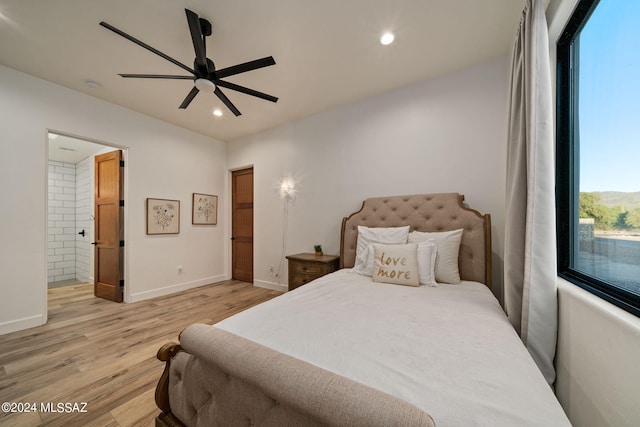 bedroom with connected bathroom, ceiling fan, and light hardwood / wood-style flooring