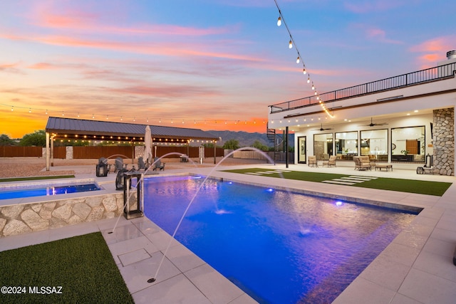 outdoor pool with a jacuzzi, fence, a ceiling fan, a gazebo, and a patio area