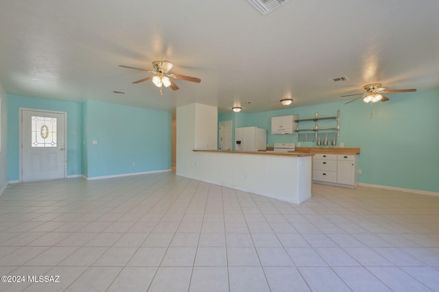 kitchen with white cabinets, light tile patterned flooring, ceiling fan, and white refrigerator with ice dispenser