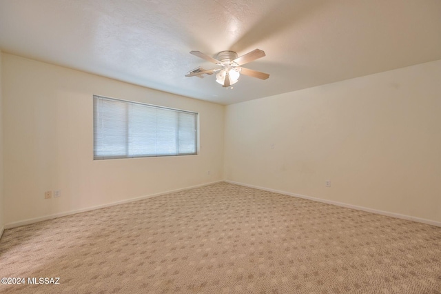 unfurnished room with ceiling fan and carpet floors