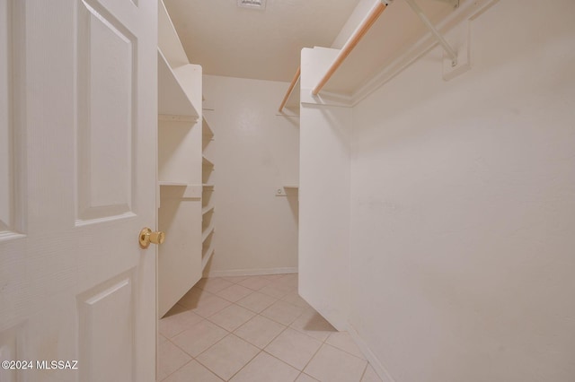 spacious closet featuring light tile patterned floors