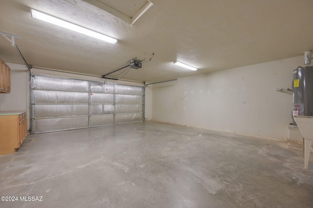 garage with gas water heater and a garage door opener