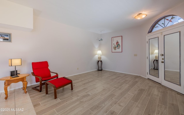 living area with light wood finished floors and baseboards