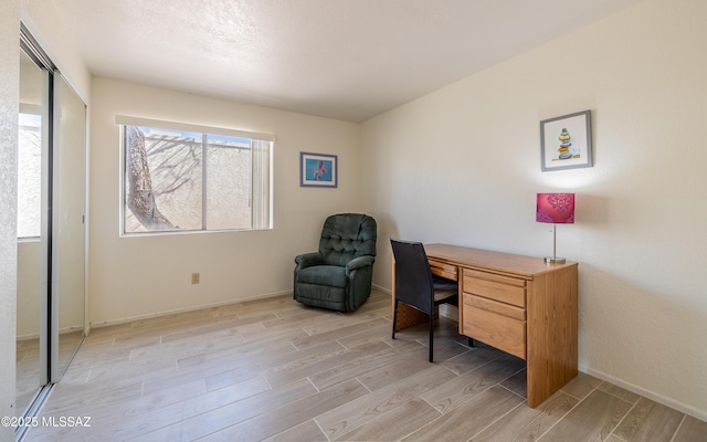 office space featuring light wood-style floors and baseboards