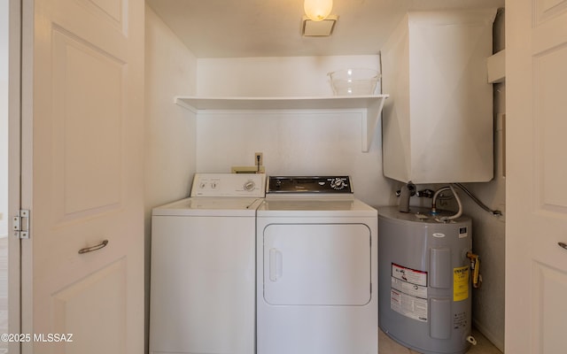 laundry area with electric water heater, separate washer and dryer, and laundry area