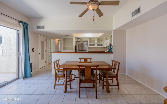 dining space featuring light tile patterned floors, visible vents, baseboards, and a ceiling fan