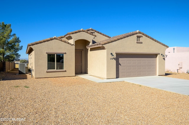 mediterranean / spanish-style home featuring a garage and central AC