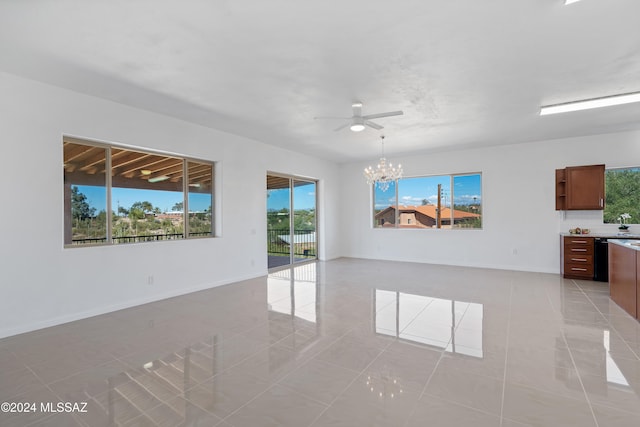 tiled spare room with ceiling fan with notable chandelier