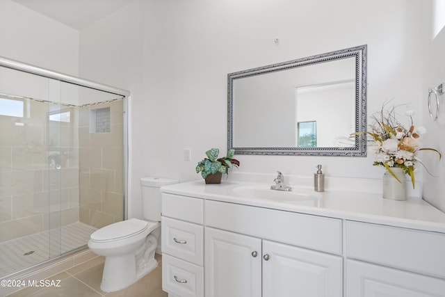 bathroom featuring tile patterned flooring, vanity, toilet, and an enclosed shower