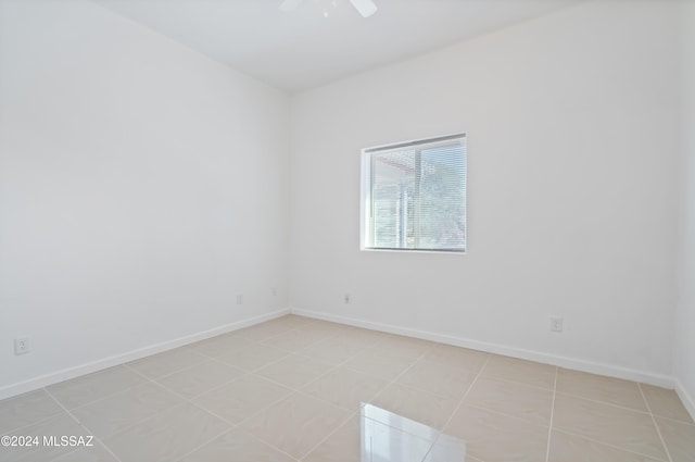 unfurnished room with ceiling fan and light tile patterned floors