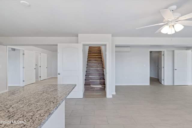 interior space featuring ceiling fan and a wall mounted AC