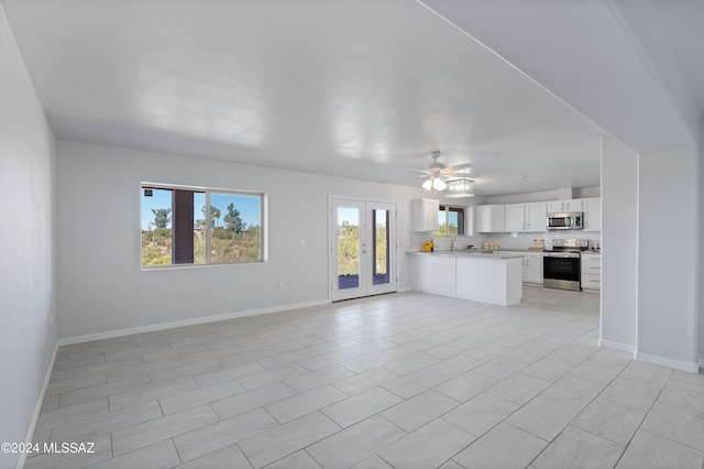 unfurnished living room with french doors, ceiling fan, and light tile patterned floors