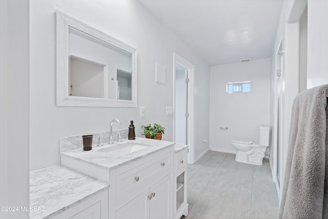 bathroom featuring vanity and toilet