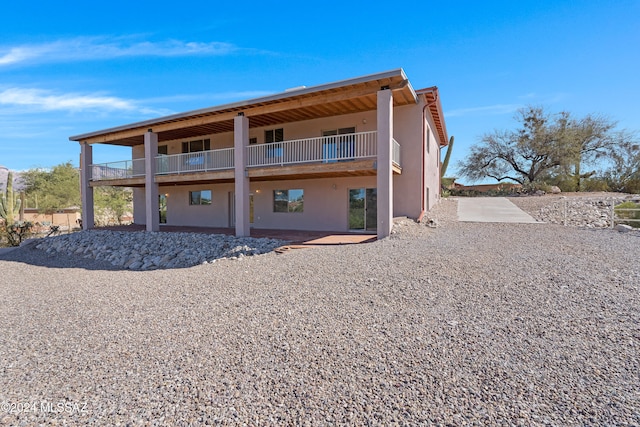 back of property featuring a balcony