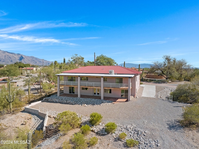 rear view of house featuring a mountain view