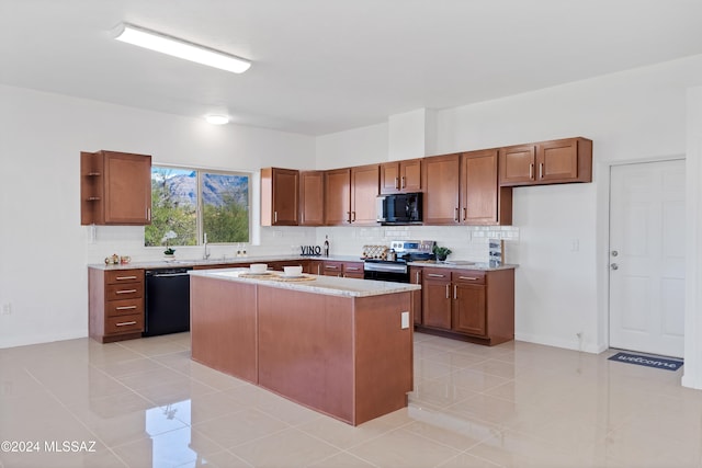 kitchen with a center island, black appliances, light tile patterned floors, sink, and backsplash