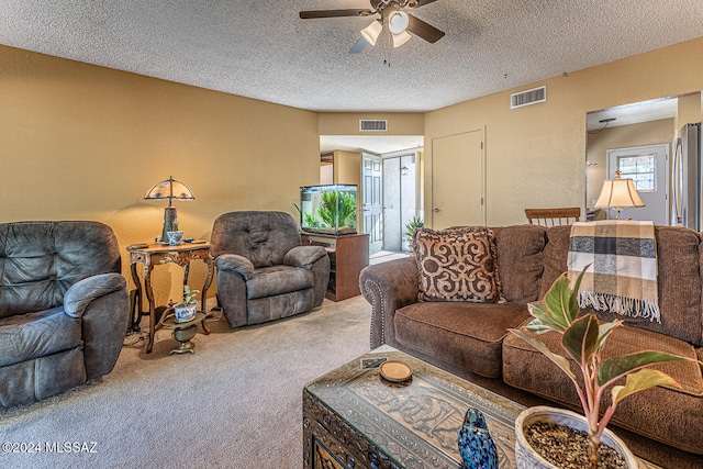 living room with carpet, a textured ceiling, and ceiling fan