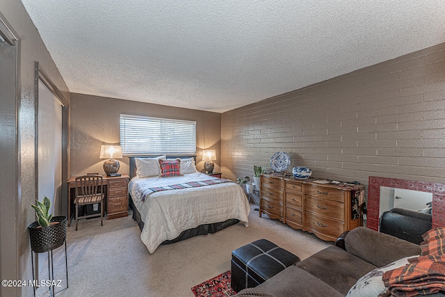 carpeted bedroom with brick wall and a textured ceiling