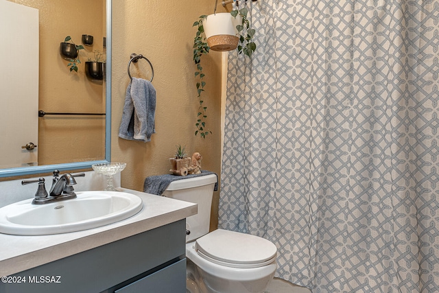 bathroom with vanity, a shower with curtain, and toilet