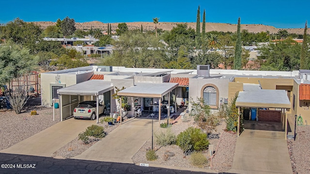 view of front of home with a mountain view and a carport